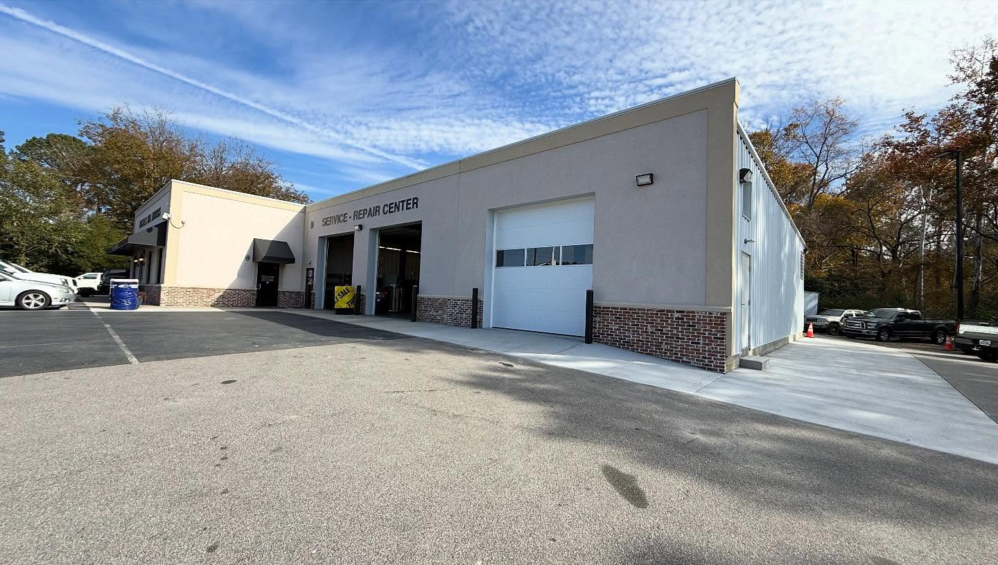 The completed Mitchell Mill Motors service and repair center in Johnston County, North Carolina, with roll-up bay doors and a brick and stucco elevation