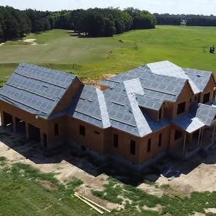 Aerial view of a custom home roof after dry-in, seen from directly above